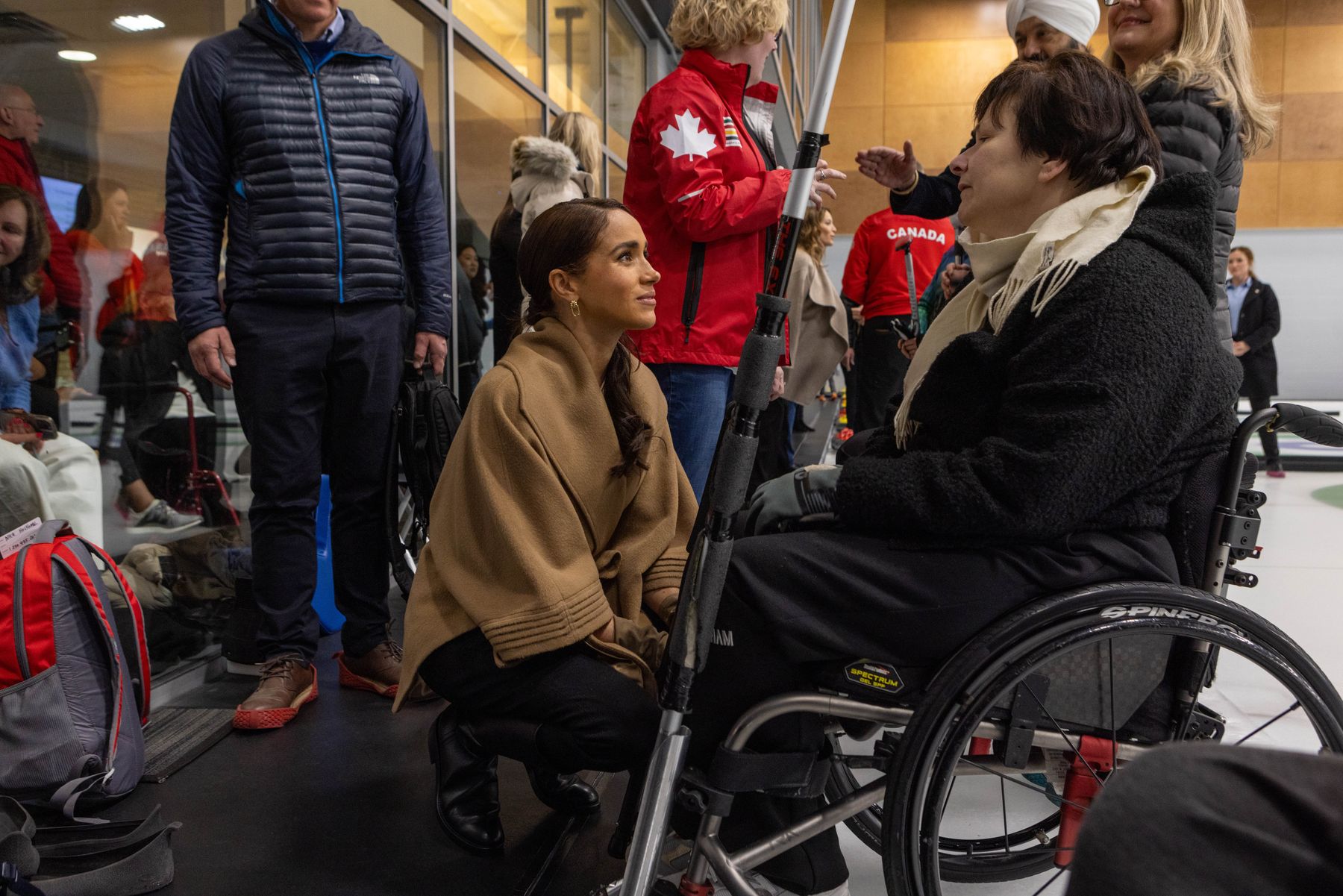 The Duchess of Sussex speaking with an Invictus competitor in a wheelchair